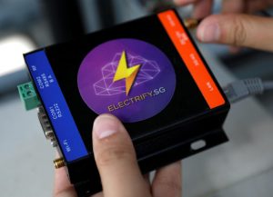 An Electrify SG engineer shows a PowerPod that will be installed to record data of photovoltaic solar panels on a rooftop in Singapore