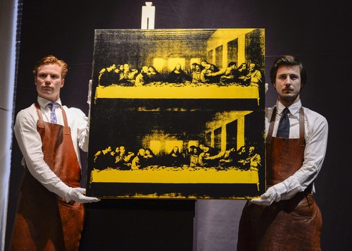 Employees at Bukowski Auction House display Andy Warhol's 'Last Supper', in Stockholm, Wednesday, May 14, 2014. The painting was sold at Bukowski Contemorary auction sale for 6.8 million euro (9.3 million dollars). (AP Photo/Per Larsson, TT news agency) SWEDEN OUT